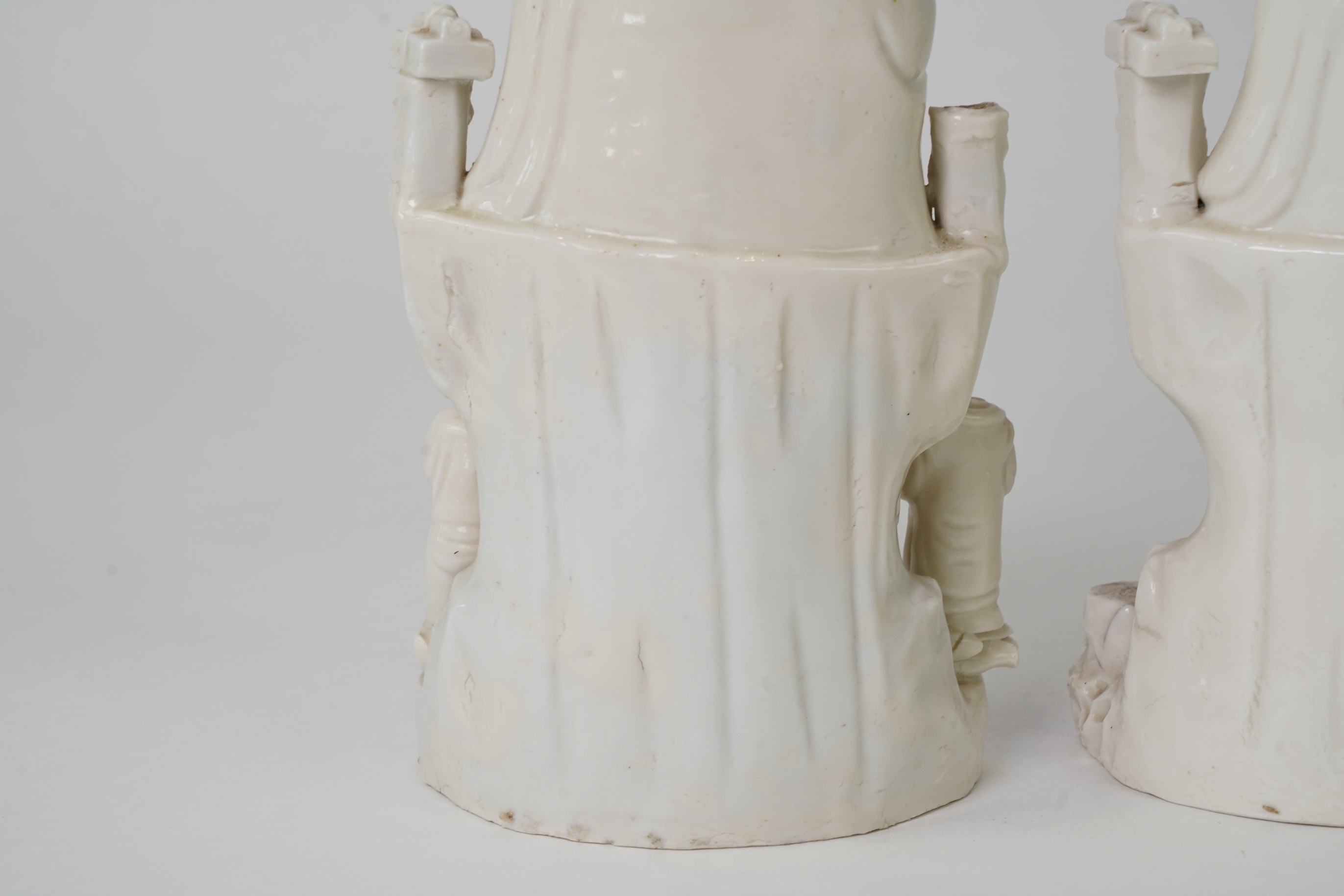 A pair of Chinese blanc de chine groups of Guanyin and children, 18th century